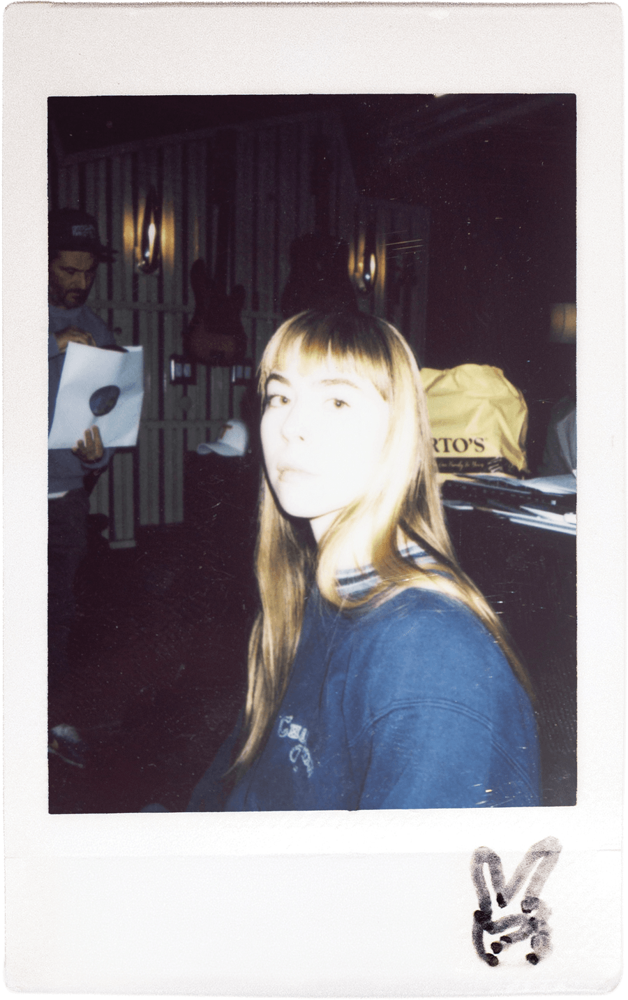Team member in a blue sweater