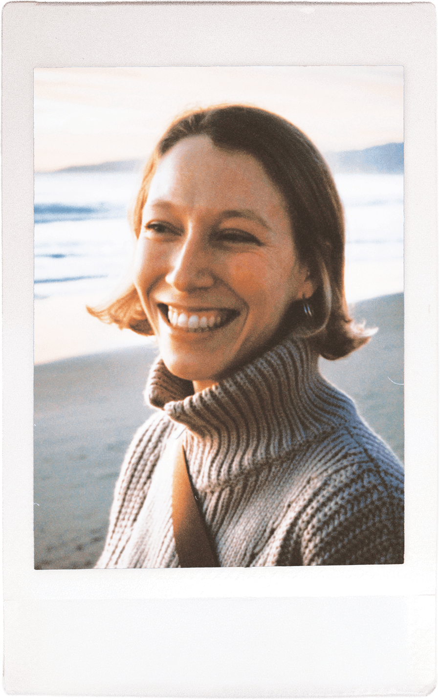 Team member in a turtleneck on a beach